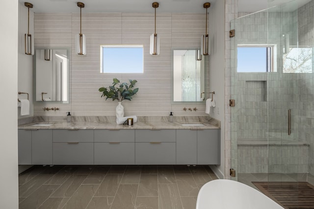 bathroom featuring plenty of natural light, vanity, and shower with separate bathtub