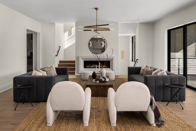 living room with hardwood / wood-style flooring and a notable chandelier