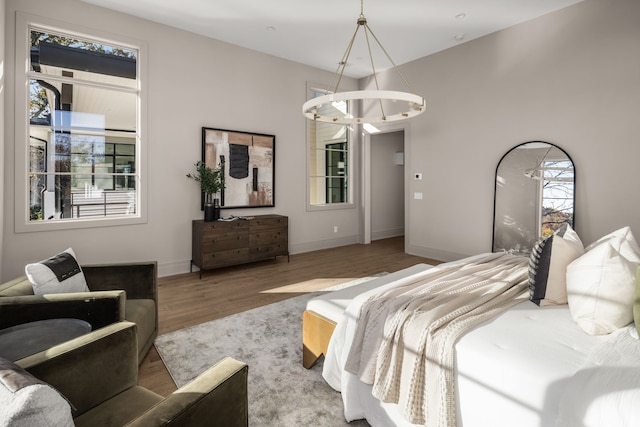 bedroom featuring a chandelier and hardwood / wood-style floors