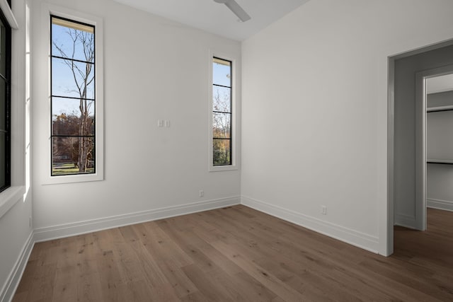 unfurnished bedroom with ceiling fan and hardwood / wood-style floors