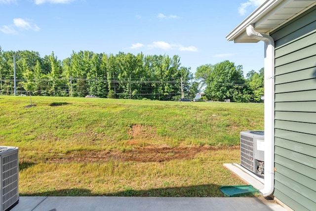 view of yard featuring central air condition unit