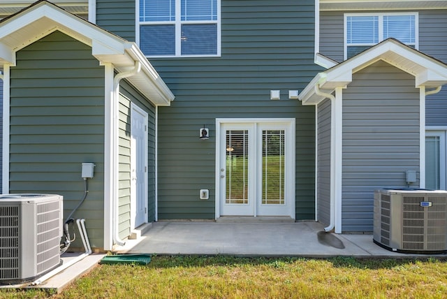 entrance to property with central AC unit and a patio area