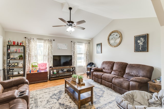 living room with lofted ceiling, ceiling fan, and light hardwood / wood-style flooring