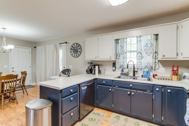 kitchen with white cabinets, black dishwasher, blue cabinetry, pendant lighting, and sink