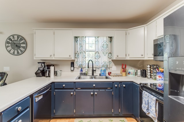 kitchen featuring blue cabinetry, white cabinets, sink, and black appliances