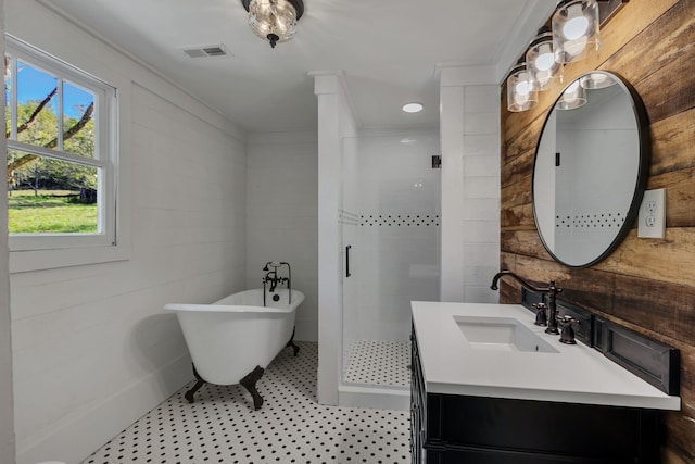 bathroom with vanity, crown molding, and separate shower and tub