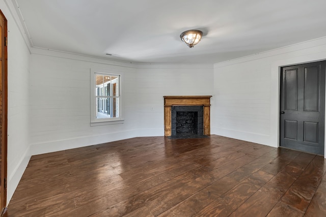 unfurnished living room featuring dark hardwood / wood-style flooring and crown molding