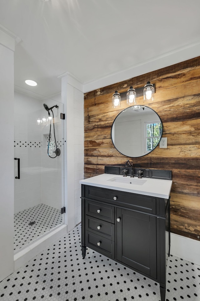 bathroom with walk in shower, vanity, tile patterned floors, and wooden walls