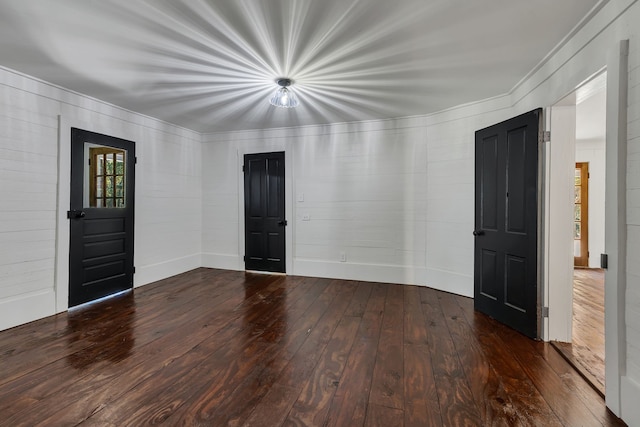 unfurnished room featuring dark hardwood / wood-style flooring