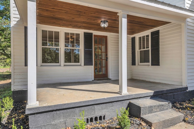 view of exterior entry with a porch