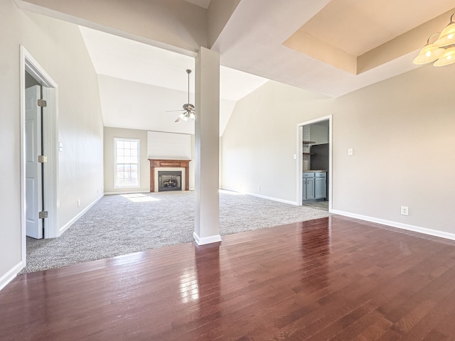 unfurnished living room featuring vaulted ceiling, carpet, and ceiling fan