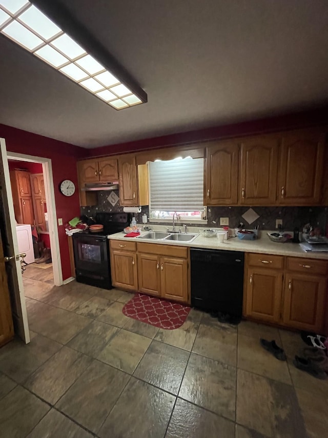kitchen featuring a sink, black appliances, light countertops, backsplash, and under cabinet range hood