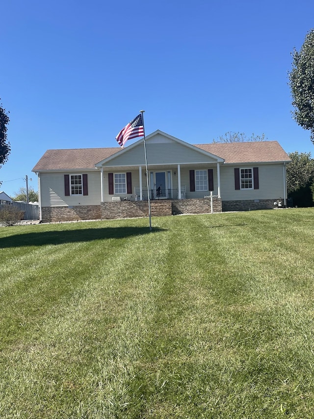 view of front facade with covered porch and a front yard