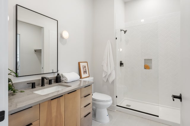 bathroom with vanity, toilet, and a shower with door