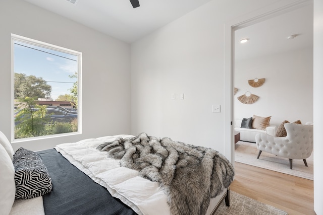 bedroom with ceiling fan and hardwood / wood-style flooring