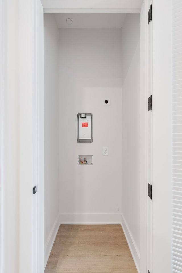 laundry room with hookup for a washing machine, light hardwood / wood-style floors, and electric dryer hookup