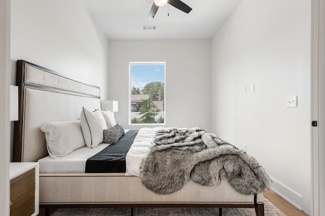 bedroom with hardwood / wood-style floors and ceiling fan