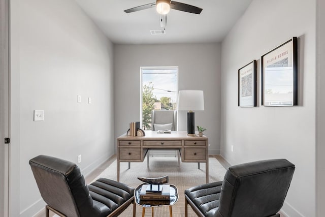 office featuring baseboards, visible vents, and a ceiling fan