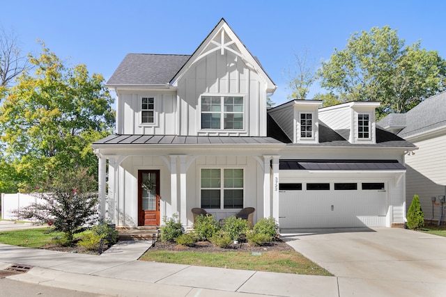 modern farmhouse featuring a garage and covered porch