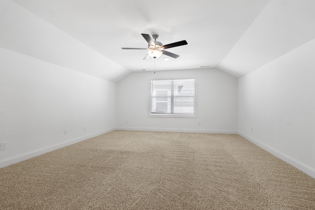 additional living space with ceiling fan, lofted ceiling, and carpet flooring