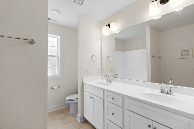 bathroom featuring tile patterned flooring, vanity, and toilet