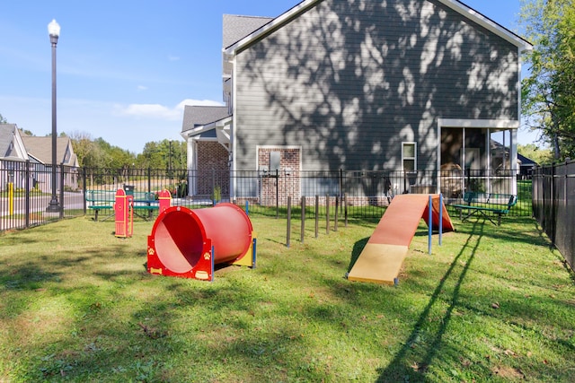 view of jungle gym featuring a lawn