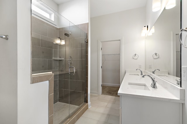 bathroom featuring tile patterned flooring, walk in shower, and vanity