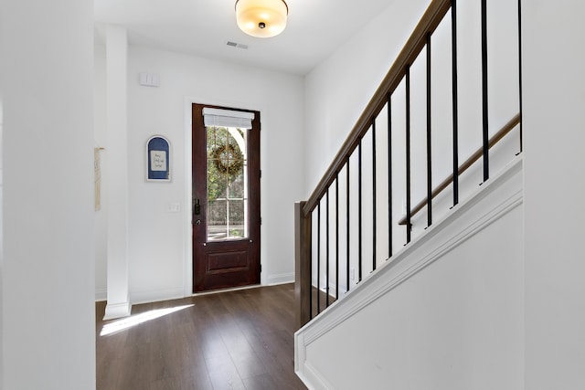 foyer entrance featuring dark wood-type flooring