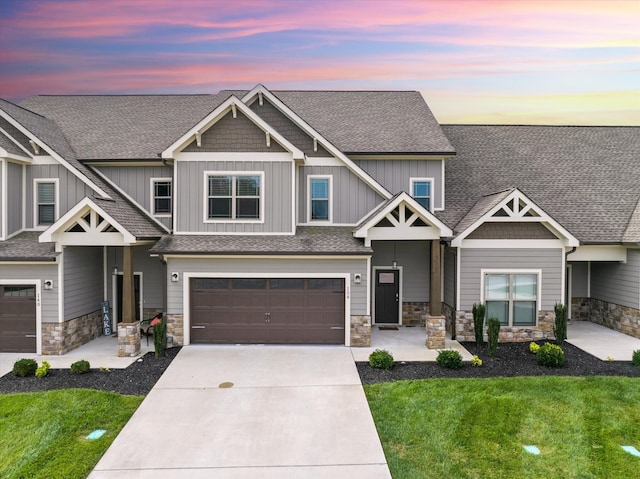 craftsman house with a yard and a garage