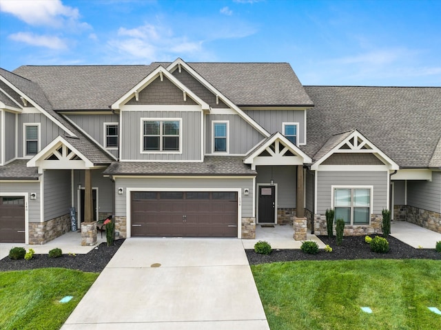 craftsman-style home featuring a garage and a front lawn