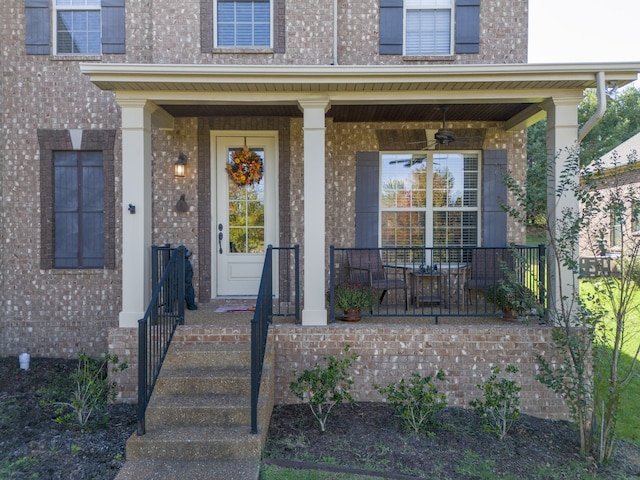 entrance to property with a porch and ceiling fan