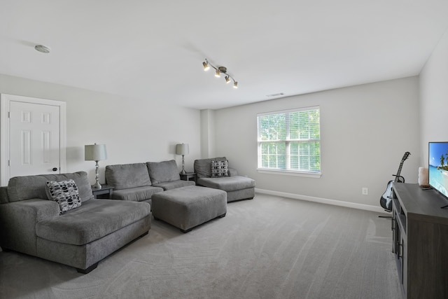 carpeted living room featuring rail lighting