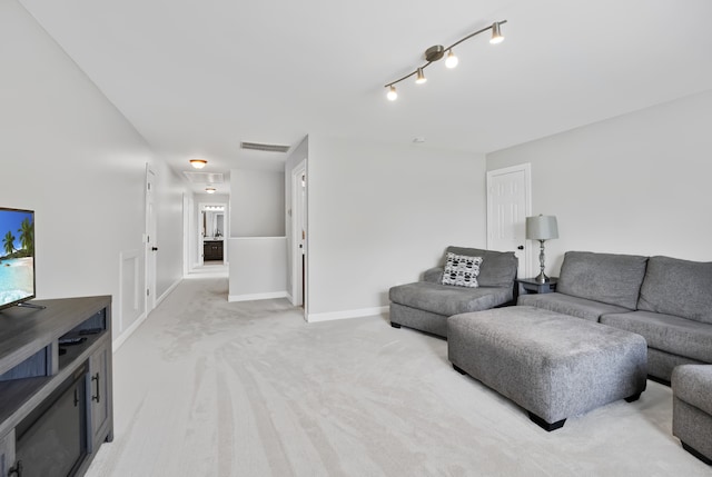 carpeted living room with rail lighting