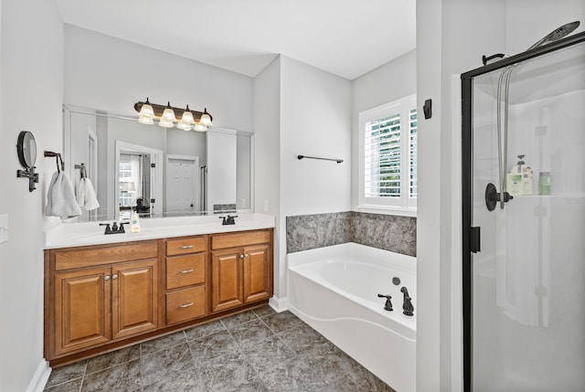 bathroom featuring tile patterned flooring, separate shower and tub, and vanity