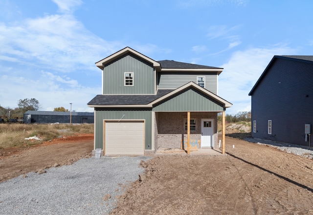 view of front of home with covered porch and a garage