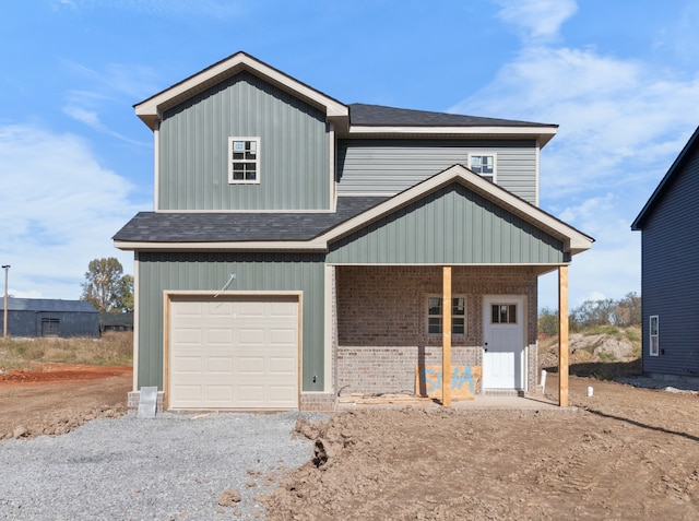 view of front of property featuring a porch and a garage