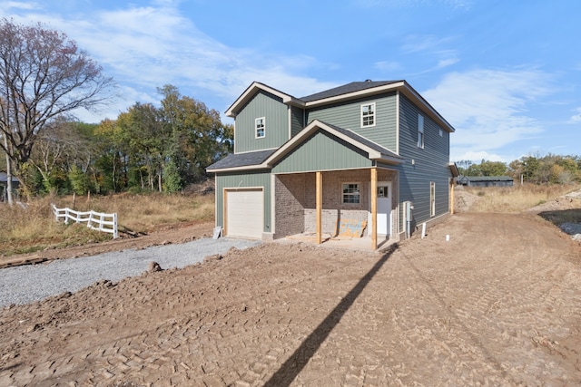 view of front of home with a porch and a garage