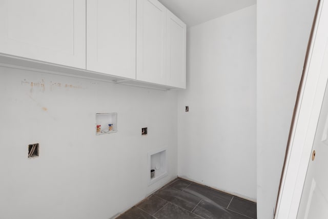 washroom with cabinets, hookup for a washing machine, and dark tile patterned flooring