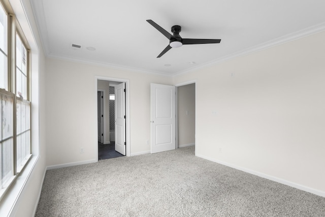 unfurnished bedroom featuring dark carpet, ceiling fan, and crown molding