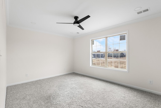 spare room featuring carpet floors, ceiling fan, and crown molding