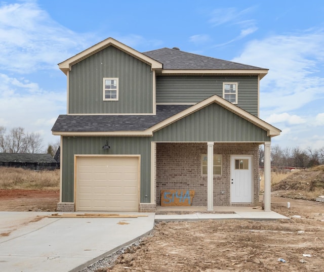 view of front of house featuring a porch and a garage