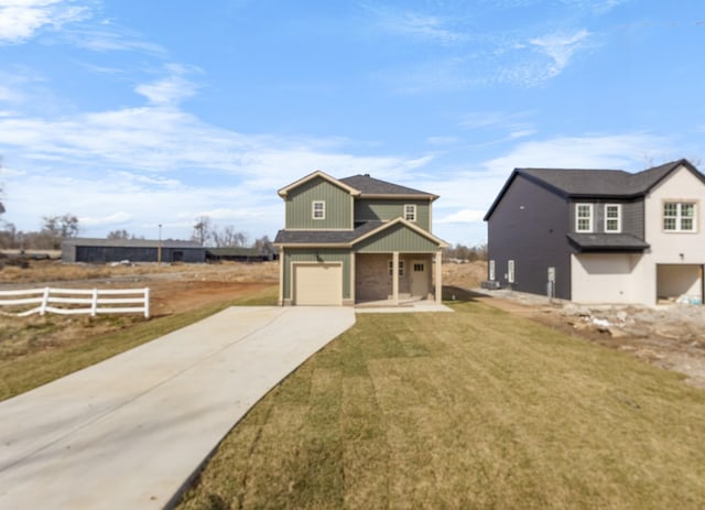 traditional-style house featuring fence, board and batten siding, concrete driveway, a front yard, and a garage