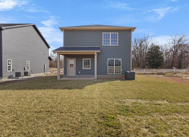 back of property with a yard, central air condition unit, a patio, and fence