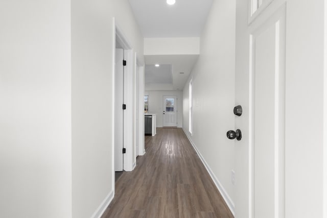 corridor with recessed lighting, dark wood-type flooring, and baseboards