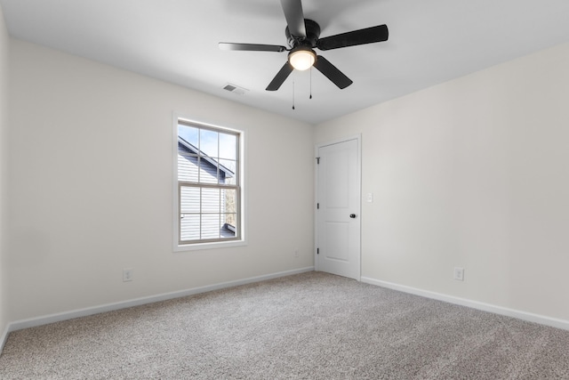 spare room featuring visible vents, carpet floors, baseboards, and a ceiling fan