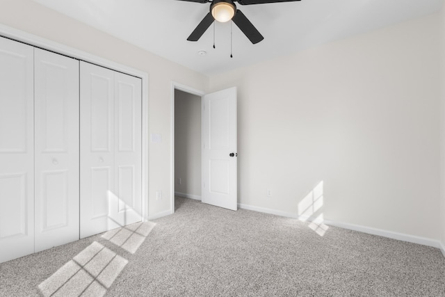 unfurnished bedroom featuring ceiling fan, baseboards, a closet, and light carpet