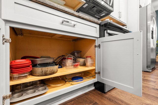 interior space with white cabinetry and wood-type flooring