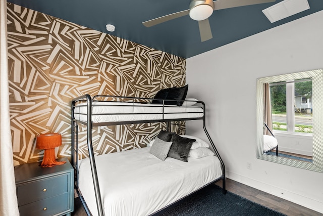 bedroom with dark hardwood / wood-style flooring and ceiling fan