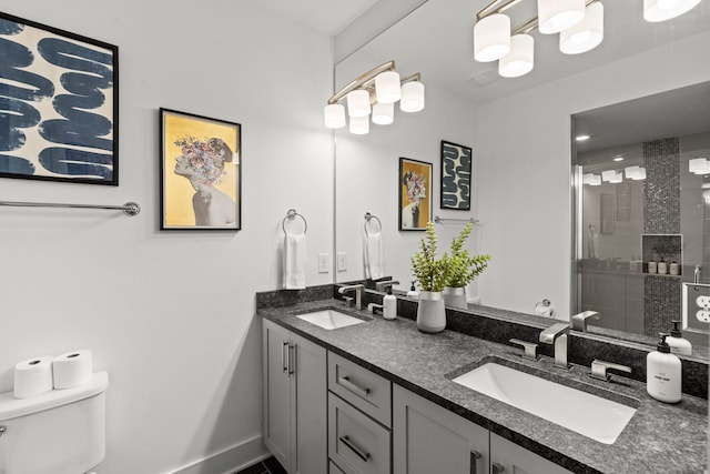 bathroom featuring vanity, tiled shower, and toilet