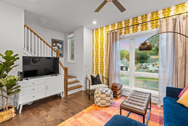 living area featuring ceiling fan, plenty of natural light, and dark hardwood / wood-style floors